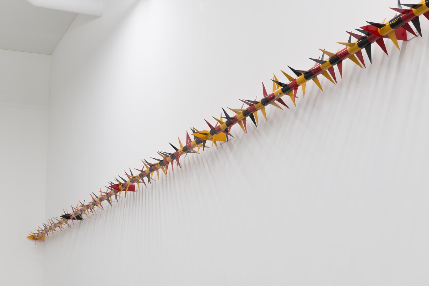 Claire Fontaine Untitled (Rotary spike: Schwarz-Rot-Gelb, Schwarz-Rot-Senf, Schwarz-Rot-Scheiße), 2016 Galvanised and painted rotary spike, tubing and fixtures  72 elements, 25 x 600 x 25 cm  