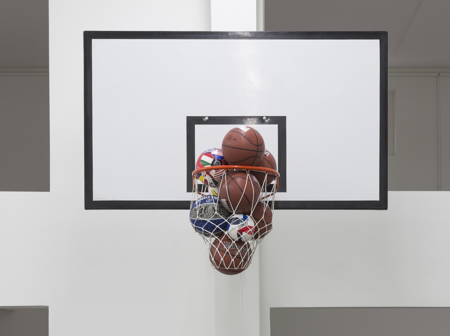 Claire Fontaine Caught, 2016 Basketball backboard, support, basketball hoop, net and various balls, 140 x 180 x 110 cm   