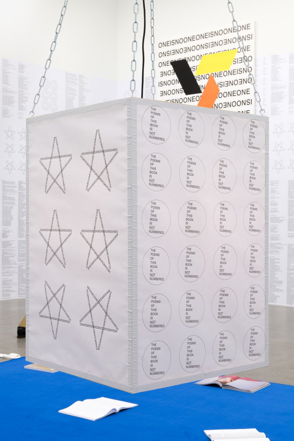 Karl Holmqvist Untitled (DIN A1 poster lantern), 2021 DIN A1 posters, wood, chains, hooks, LED lightbulb dimensions variable