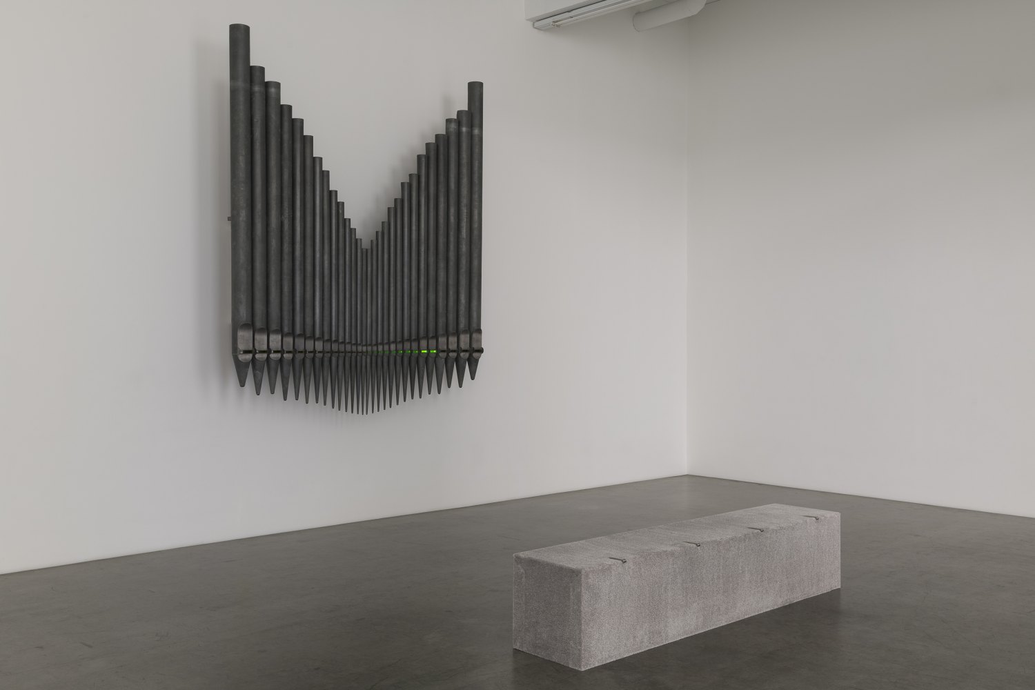 Jeremy Shaw Half-Life of Grace (1958), 2026 28 decommissioned zinc-based metal alloy church organ pipes, hand-blown uranium glass, ultra violet (UV) lights, electronic circuitry, transducer speakers, audio, stainless steel 300 x 255 x 58 cm