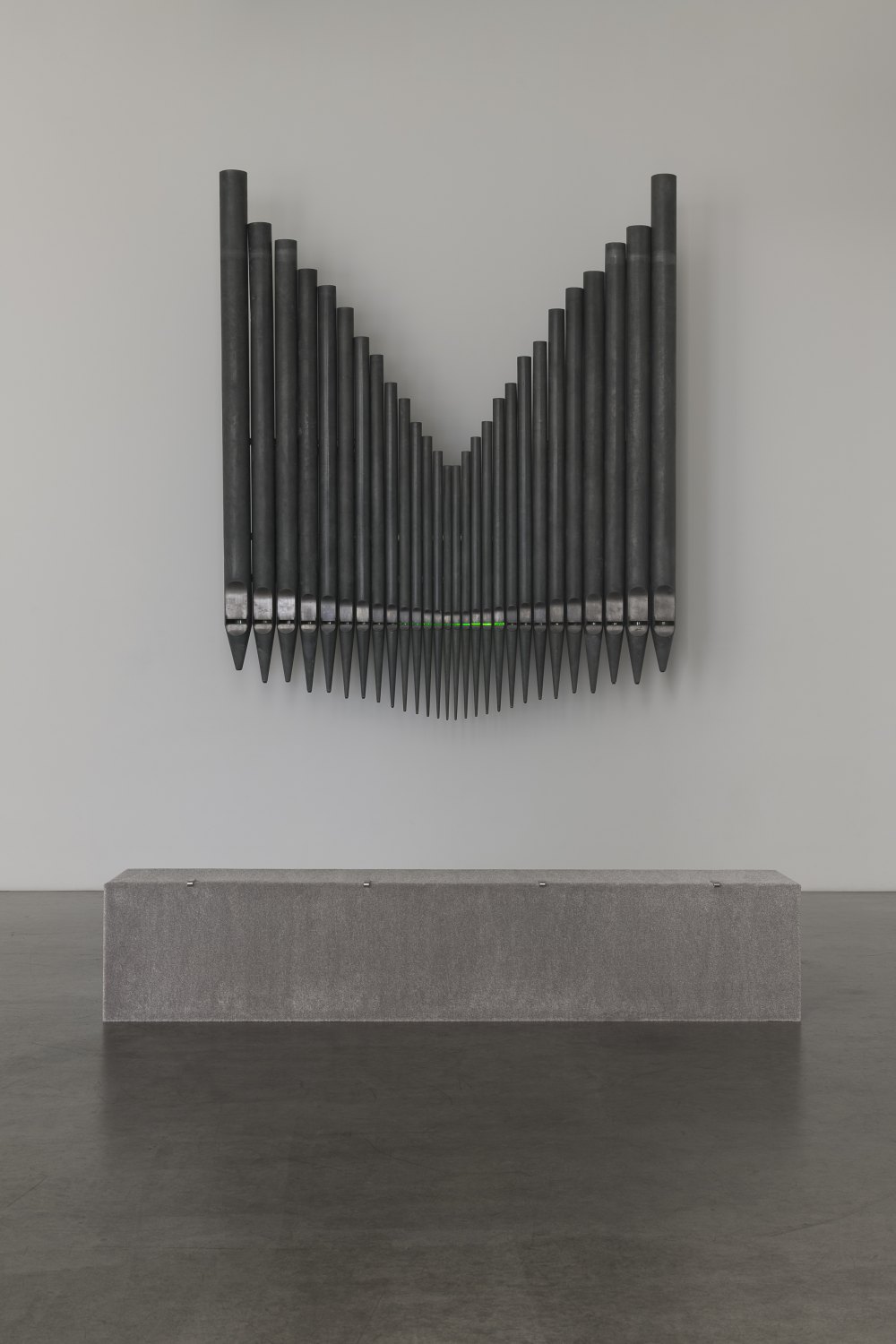 Jeremy Shaw Half-Life of Grace (1958), 2026 28 decommissioned zinc-based metal alloy church organ pipes, hand-blown uranium glass, ultra violet (UV) lights, electronic circuitry, transducer speakers, audio, stainless steel 300 x 255 x 58 cm