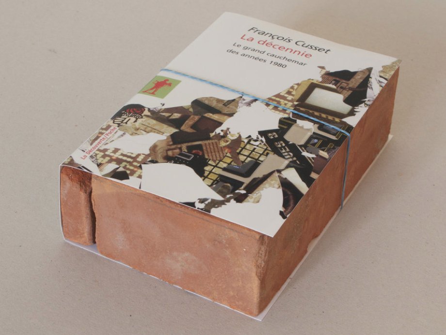 Claire Fontaine La décennie brickbat, 2009 Brick fragments and digital archival print with optional elastic band, 18.9 × 12.5 × 5.6 cm