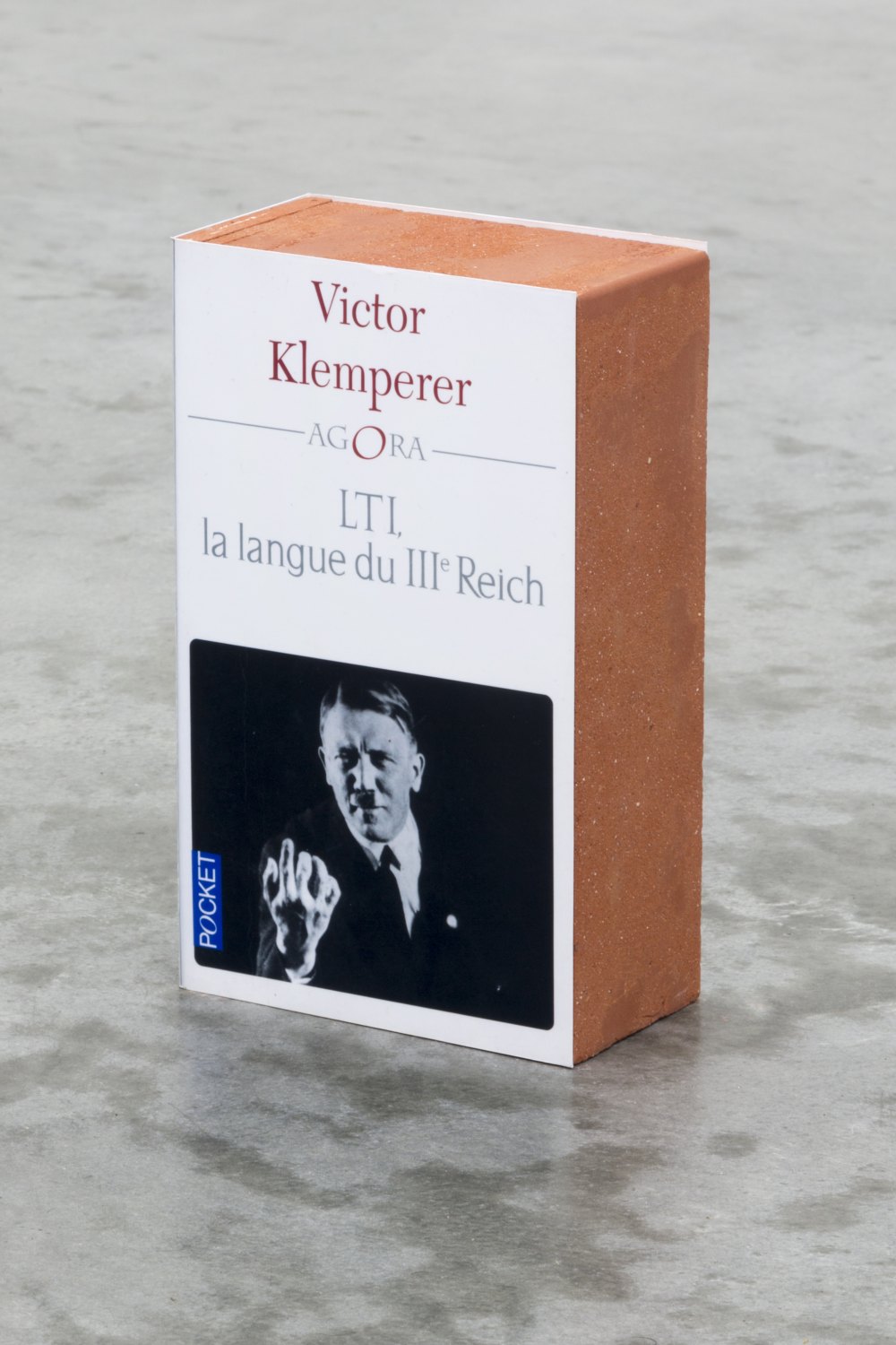 Claire Fontaine LTI, la langue du IIIème Reich brickbat, 2014 Brick fragments and digital archival print with optional elastic band, 17.8 × 10.8 × 5.8 cm