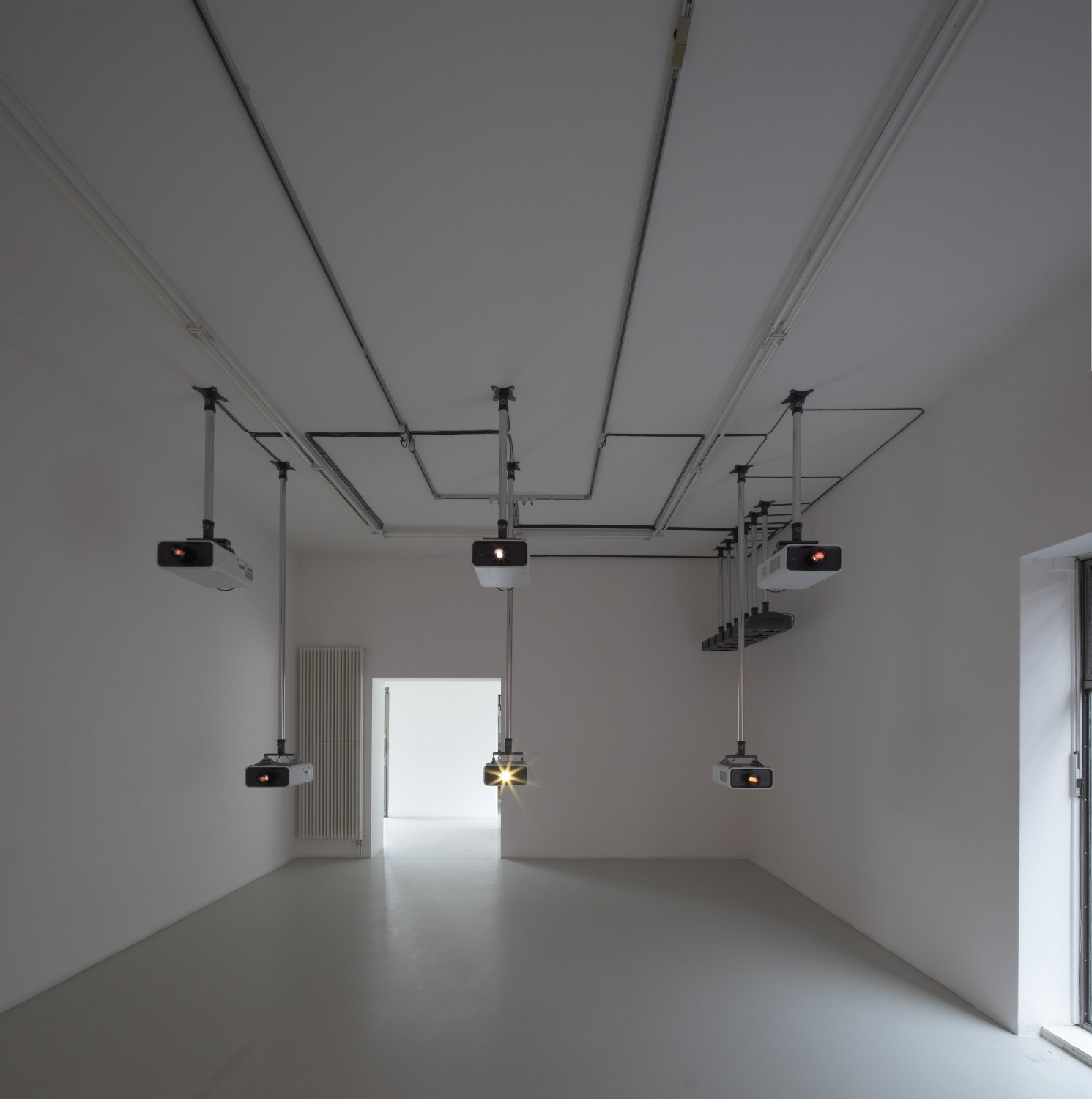 Hilary Lloyd  Column, 2009  6 Sanyo PLC-XP100 Projectors, 6 Pioneer DVD-V7300D Players, 12 Unicol Suspension Units, dimensions variable