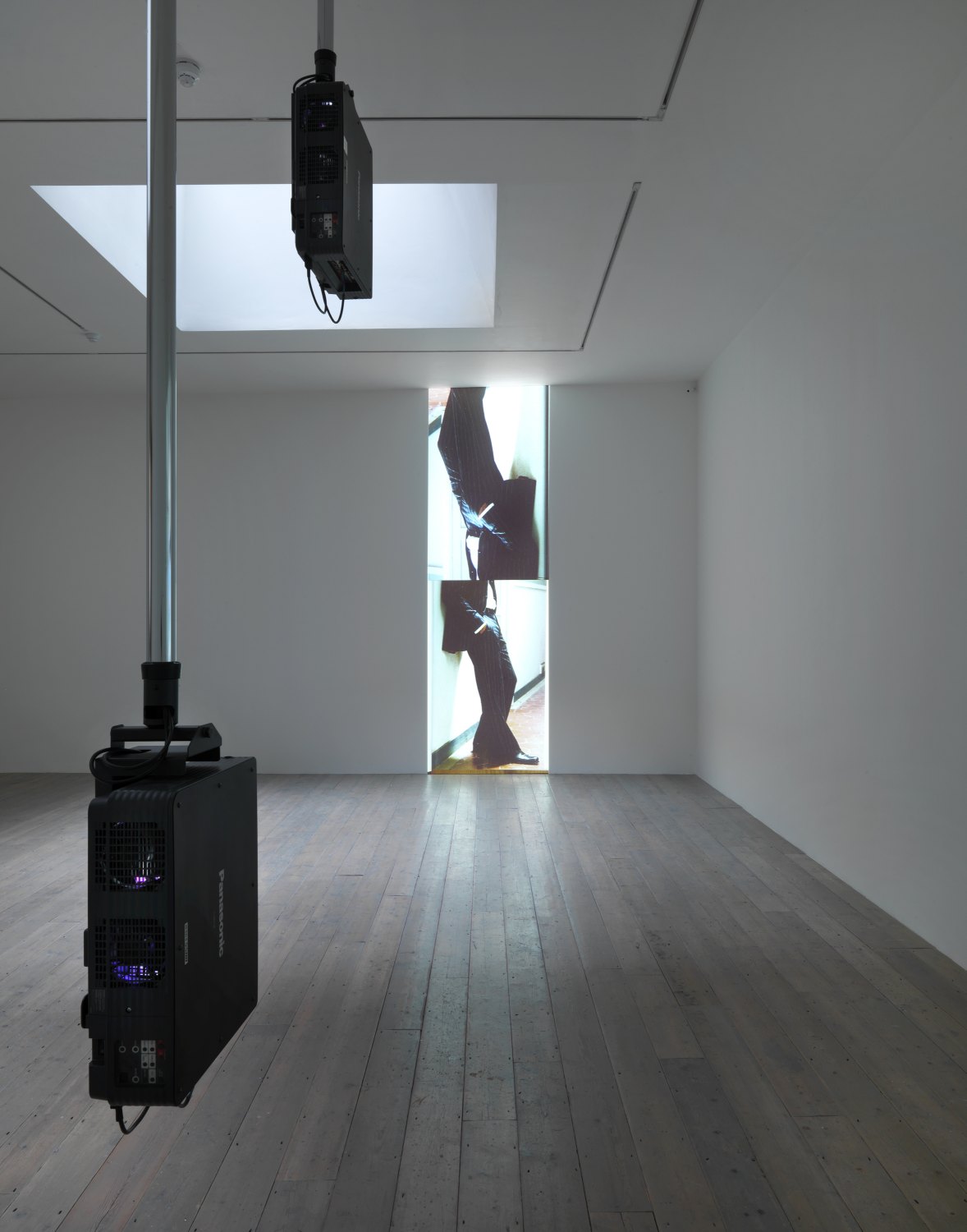 Hilary Lloyd   Trousers, 2010    2 pioneer PT-DW5100U projectors, 2 pioneer DVD-V7300D players, 4 Unicol suspension units, dimensions variable   